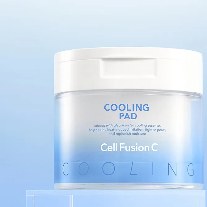 A clear blue-and-white Cell Fusion C Cooling Pad jar with a white lid on a clear block, on a light blue background