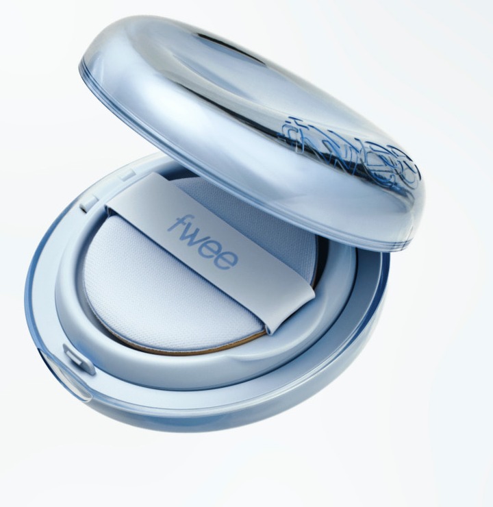 An open translucent sky-blue fwee cushion compact tilted on a pale background, with a light-blue puff and a strap printed 'fwee' inside.