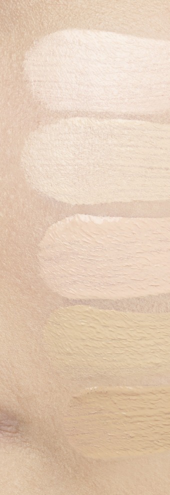 Five horizontal foundation swatches on bare skin, from the palest at the top to a light yellow-beige at the bottom.