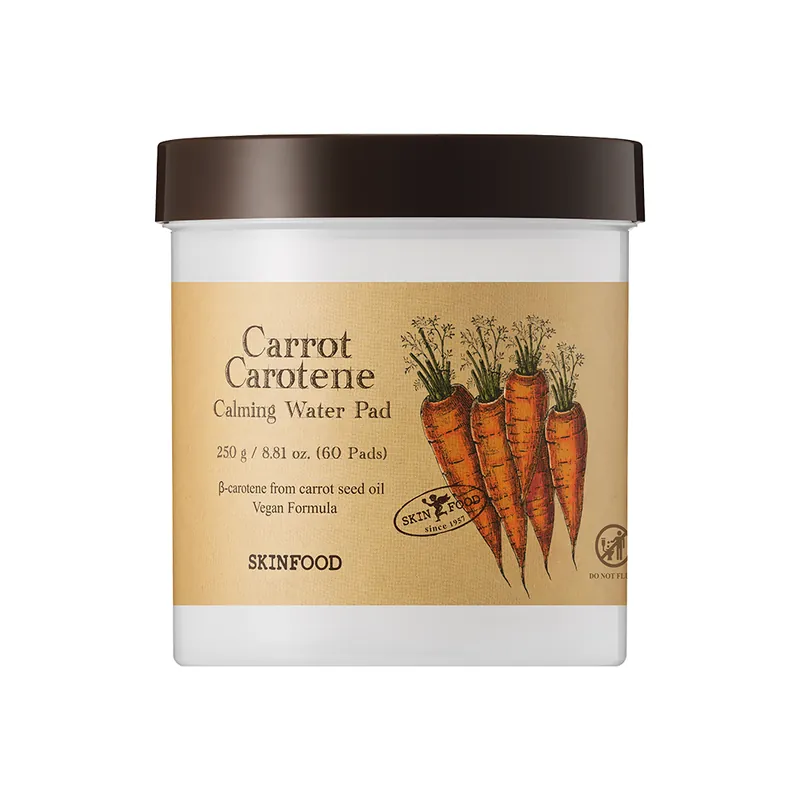 A wide jar with a dark brown lid and a kraft-paper label showing carrots, on white